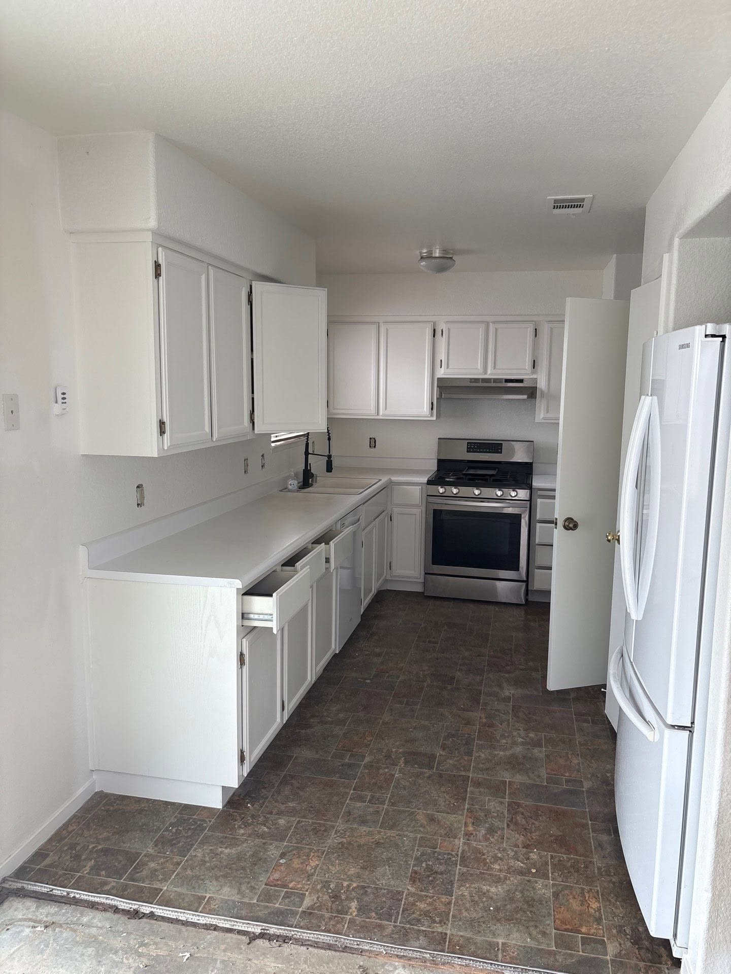 Kitchen after renovation — painted white cabinets modern look
