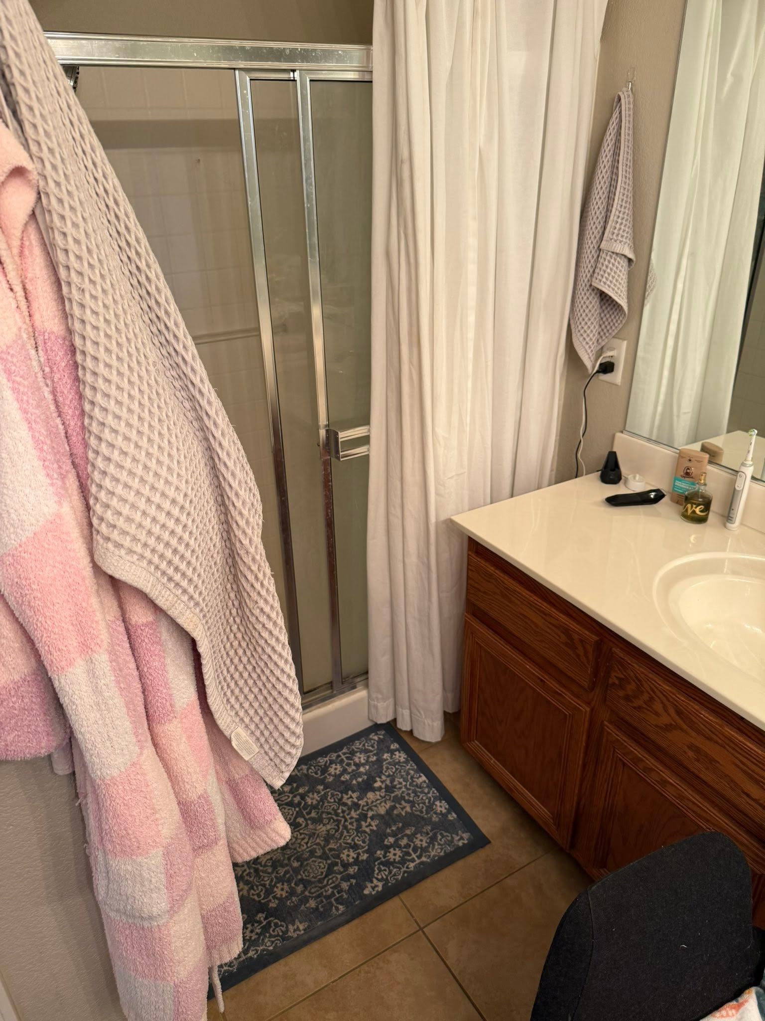 Bathroom before renovation — old sliding glass shower